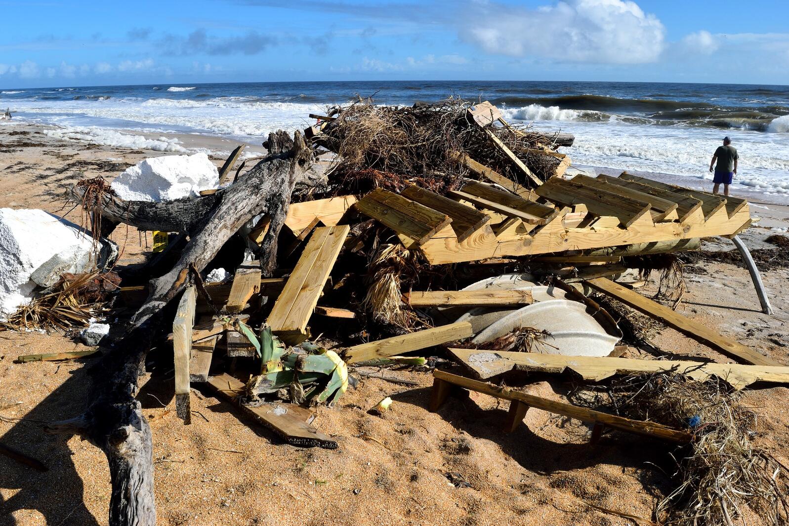Hurricane debris piled up on a beach.