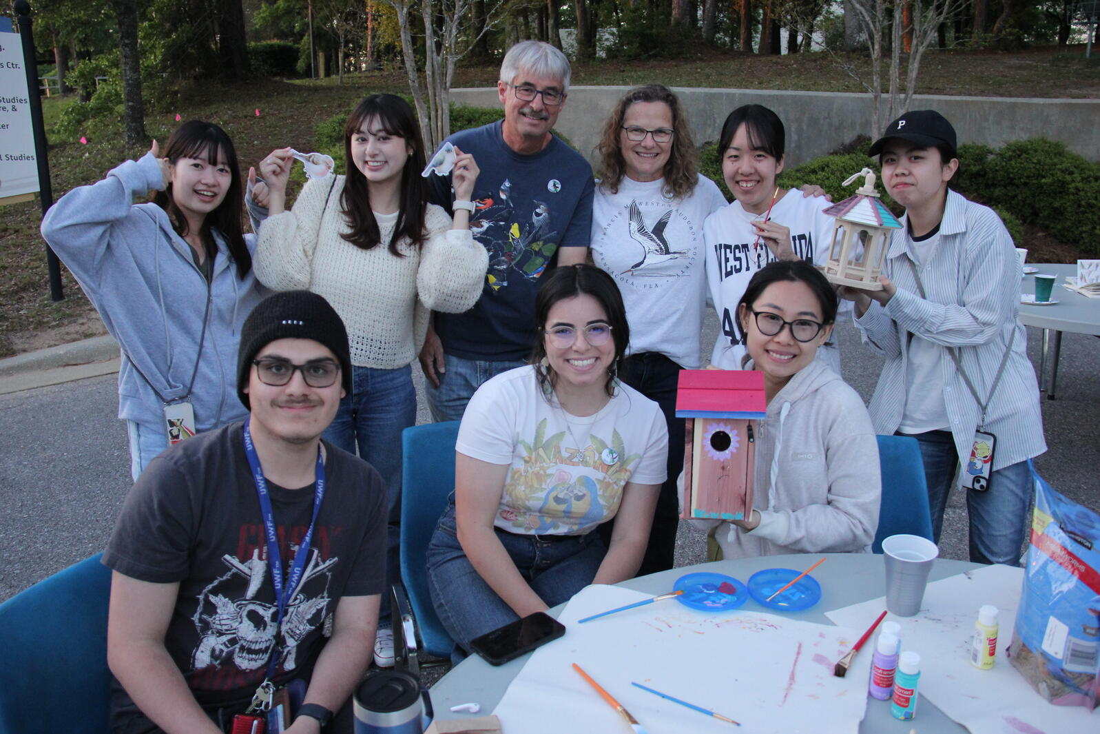 Group of people sitting around a table and smiling.