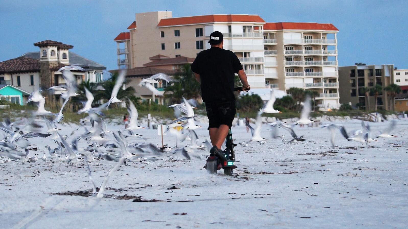 man on a scooter on the beach