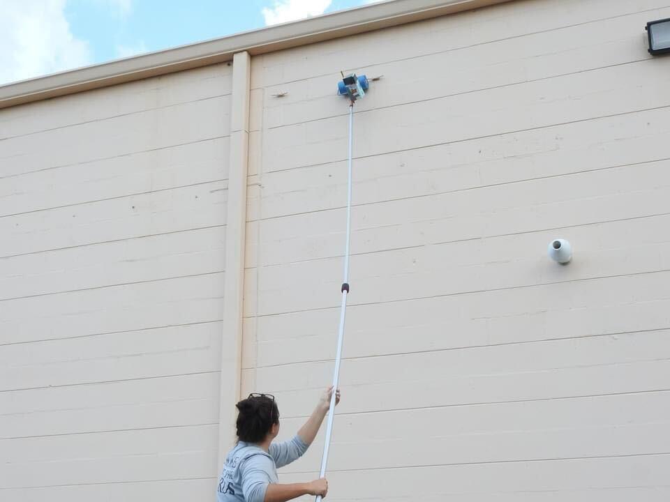 Using a chick-a-boom to place a chick back on the roof.