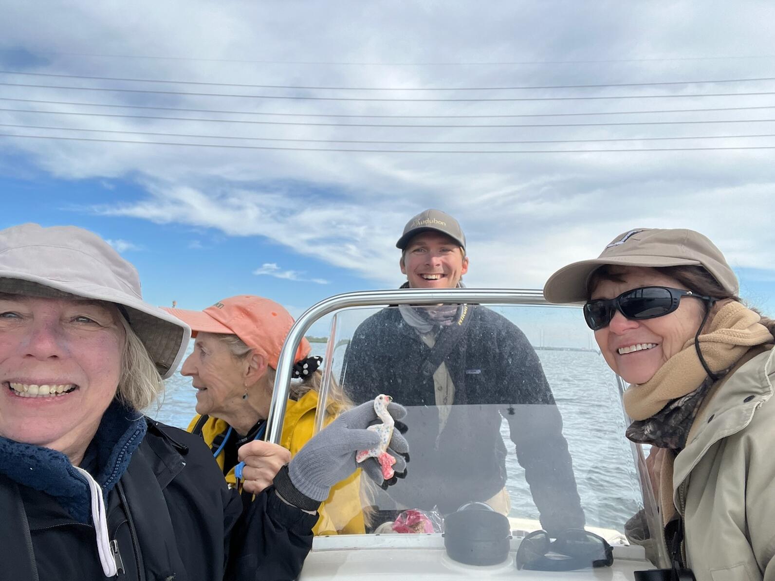 three people sitting in a boat