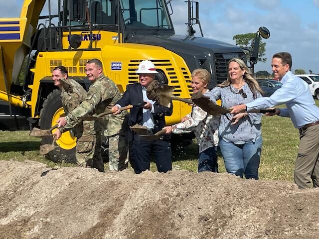 Groundbreaking at the C-23/24 Stormwater Treatment Area. People shovel dirt with a large truck in the background. Photo: Paul Gray/Audubon Florida.