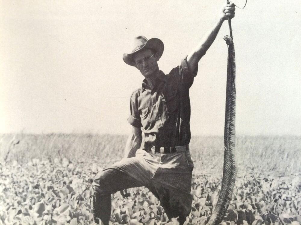 Black and white photo of man with snake