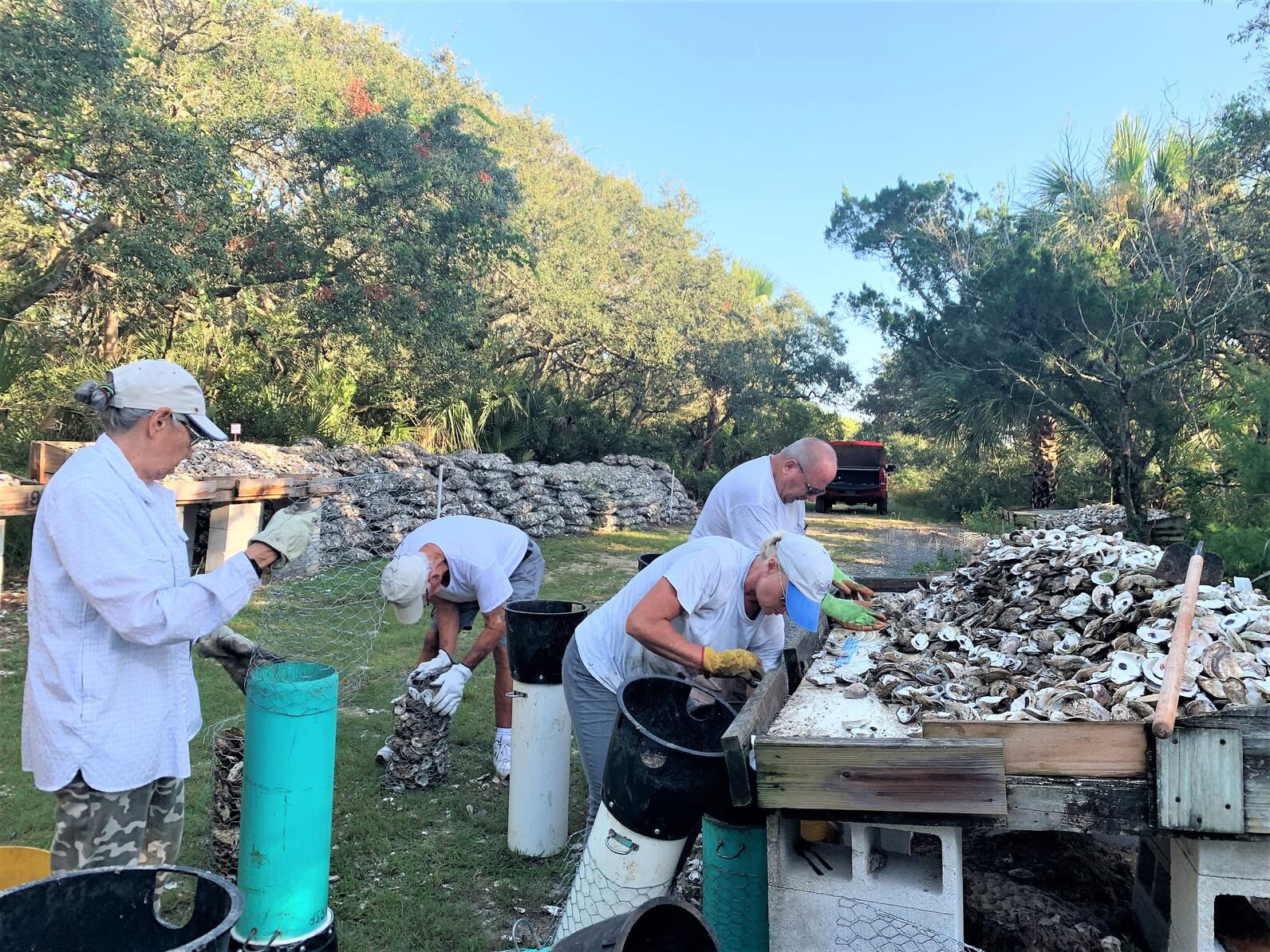 People assembling oyster reef materials